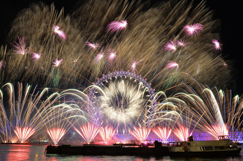 Fireworks light up the sky over the London Eye in central London during New Year's celebrations. (Photo: John Stillwell - PA Images via Getty Images)