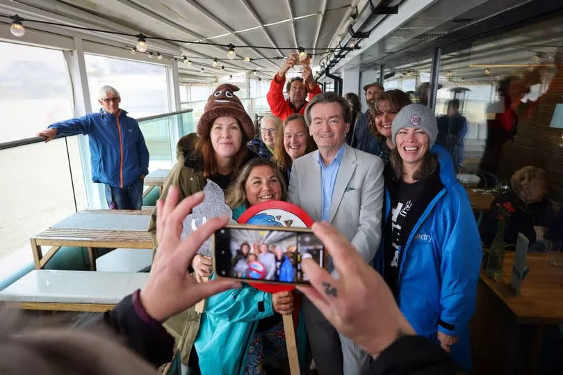 Environmental campaigner and former Undertones frontman Feargal Sharkey meets supporters including sea swimmers at Gyllyngvase Beach in Falmouth