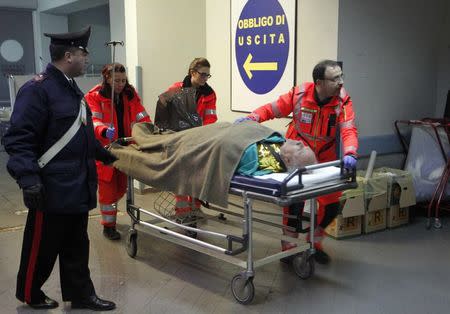 A person rescued from the Norman Atlantic vessel in the Adriatic sea is carried by medics off the ambulance as they arrive at the Antonio Perrino hospital in Brindisi, December 28, 2014. REUTERS/Ciro De Luca