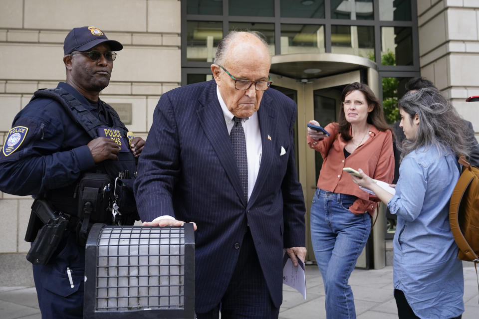 FILE - Former New York City Mayor Rudy Giuliani departs the federal courthouse, Friday, May 19, 2023, in Washington. A review panel says former New York Mayor Rudolph Giuliani should be disbarred in Washington for how he handled litigation challenging the 2020 election on behalf of then-President Donald Trump. (AP Photo/Patrick Semansky, File)