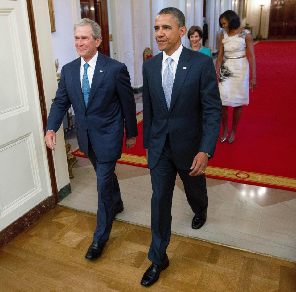 President Barack Obama and former President George W. Bush, followed by first lady Michelle Obama and former first lady Laura Bush, arrive in the East Room of the White House in Washington, Thursday, May 31,2012, for the unveiling of the Bush's portraits.