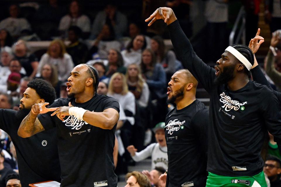 The Celtics bench celebrates in the second quarter of Game 3 of the Eastern Conference semifinals, May 11, 2024, in Cleveland.