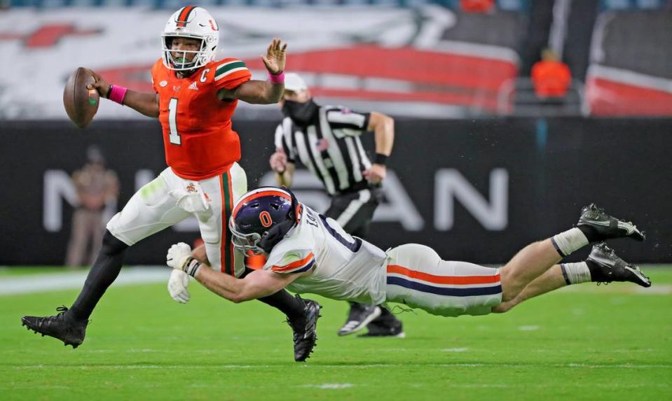 Miami Hurricanes quarterback D’Eriq King (1) is tackled by Virginia Cavaliers Zane Zandier (0) in the second quarter at Hard Rock Stadium in Miami Gardens, Florida, Saturday, October 24, 2020.