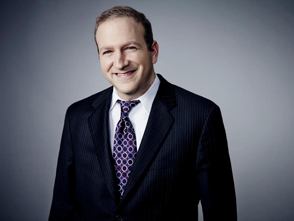 White man with tie and white shirt and dark jacket