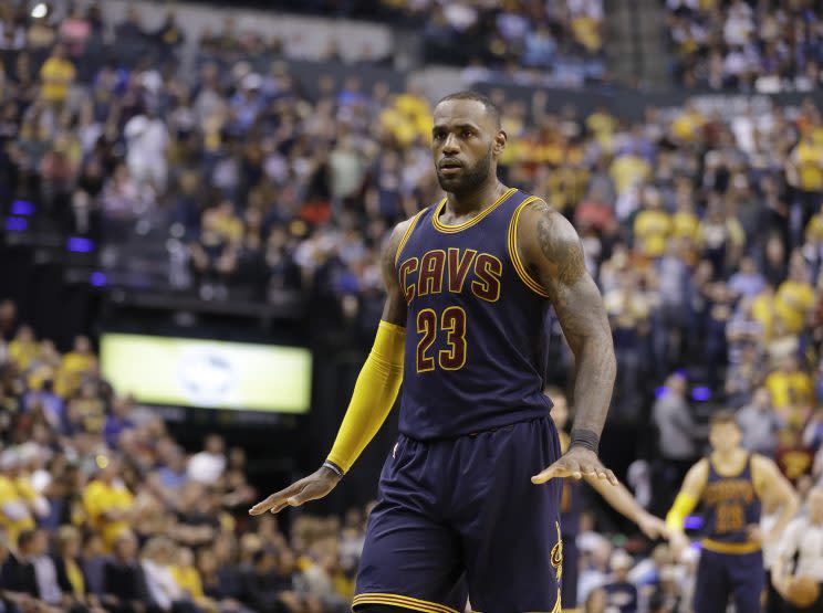 LeBron James celebrates his travel. (AP)