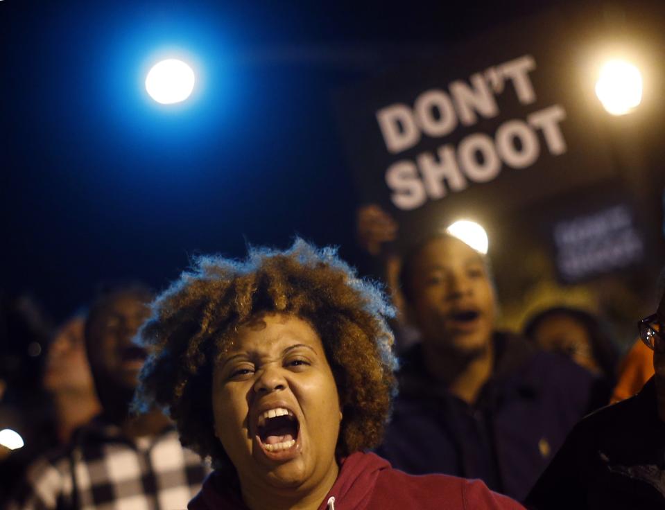 Protesters cheer after blocking an intersection after a vigil in St. Louis, Missouri, October 9, 2014. A 32-year-old white St. Louis police officer fatally shot 18-year-old Vonderrit Myers Jr. after the officer, who was off duty working for a private security company, saw Myers and two friends running and pursued them, according to a statement issued by the St. Louis police department. (REUTERS/Jim Young)