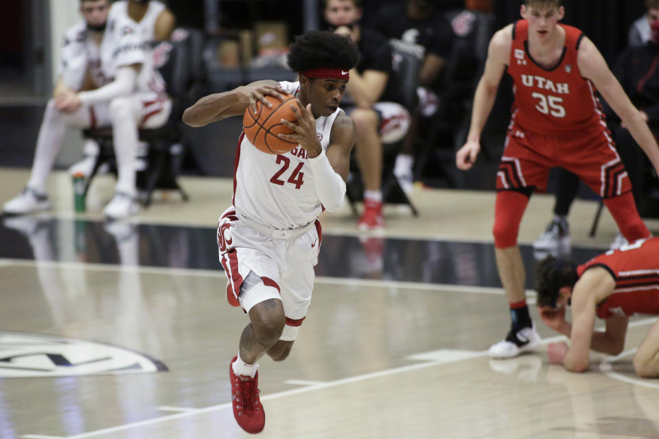 Washington State guard Noah Williams gets control of the ball after a scramble for a rebound following his missed shot during the second half of the team's NCAA college basketball game against Utah in Pullman, Wash., Thursday, Jan. 21, 2021. (AP Photo/Young Kwak)