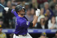 Colorado Rockies' Sean Bouchard follows the flight of his double off San Diego Padres pitcher Robert Suarez in the ninth inning of a baseball game Monday, April 22, 2024, in Denver. (AP Photo/David Zalubowski)