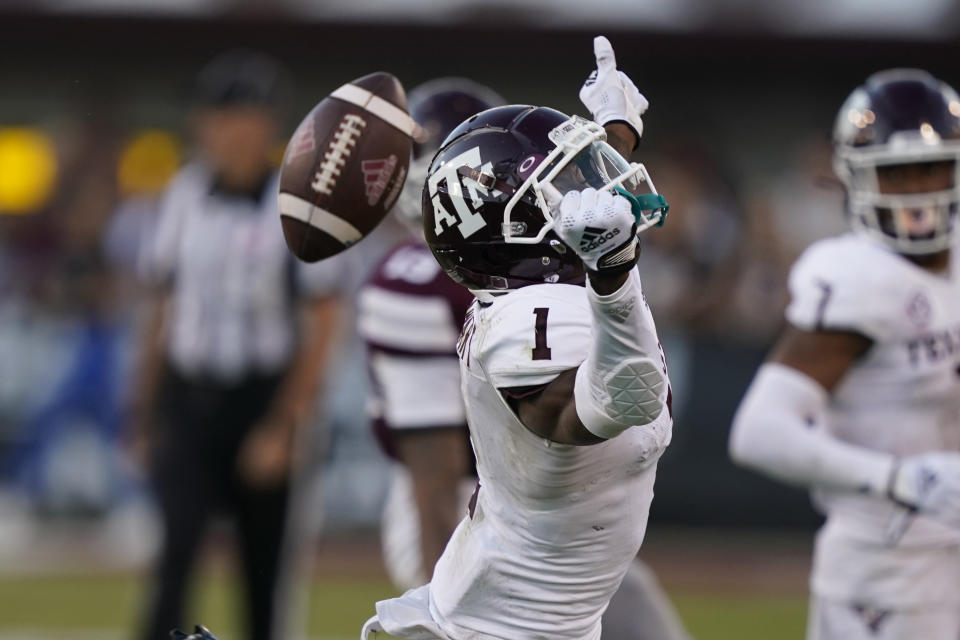 Texas A&M wide receiver Evan Stewart (1) looses a pass as Mississippi State cornerback Emmanuel Forbes intercepts it during the second half of an NCAA college football game against Mississippi State in Starkville, Miss., Saturday, Oct. 1, 2022. (AP Photo/Rogelio V. Solis)