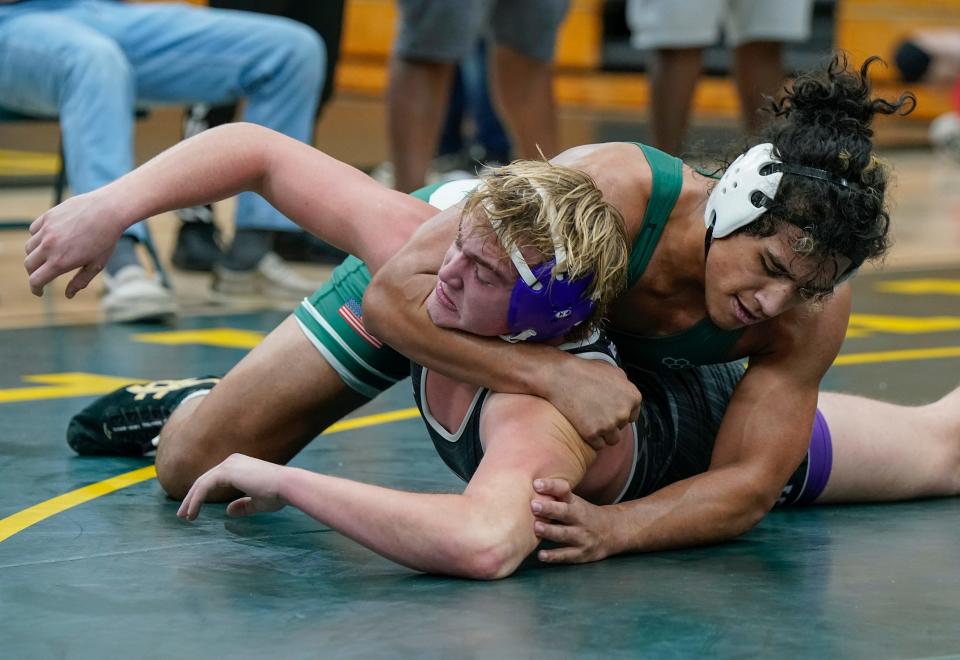 Flagler Palm Coast's Ethan Laupepa tries to flip Fletcher's Joseph Kohlhaas for a pin during the Region 1-3A Tournament at DeLand High School, Saturday, Feb. 24, 2024.