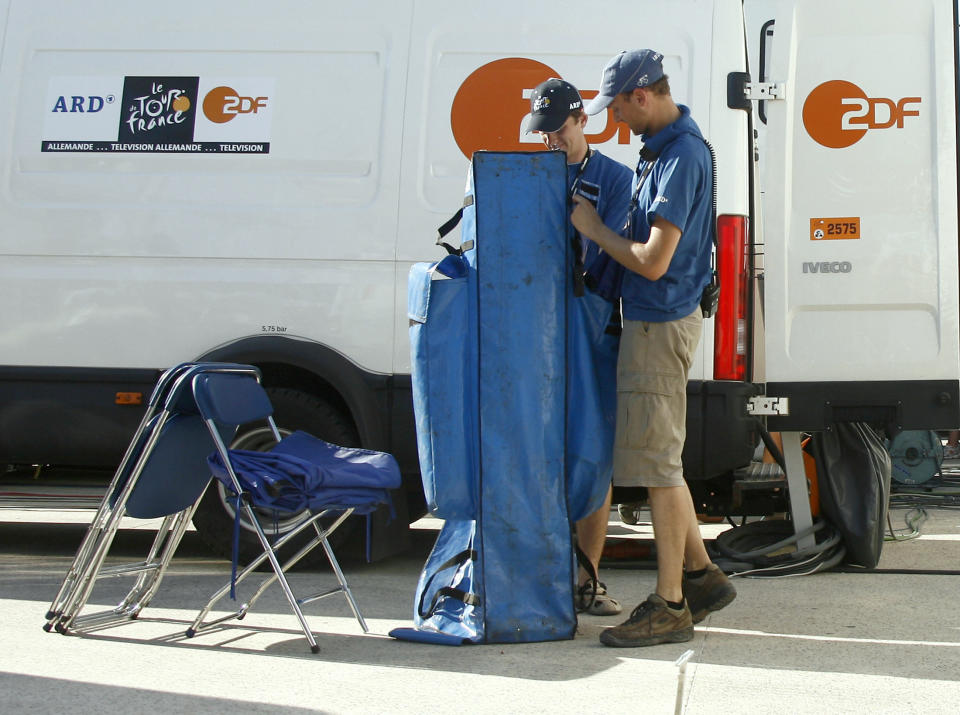 German television network ZDF crew members dismantle their setup in the technical zone at the stage arrival site of Marseille, July 18, 2007, where they and sister network ARD announced that they were stopping their Tour de France coverage after German cyclist Patrik Sinkewitz of the T-Mobile was tested positive for testosterone.      REUTERS/Stefano Rellandini     (FRANCE)