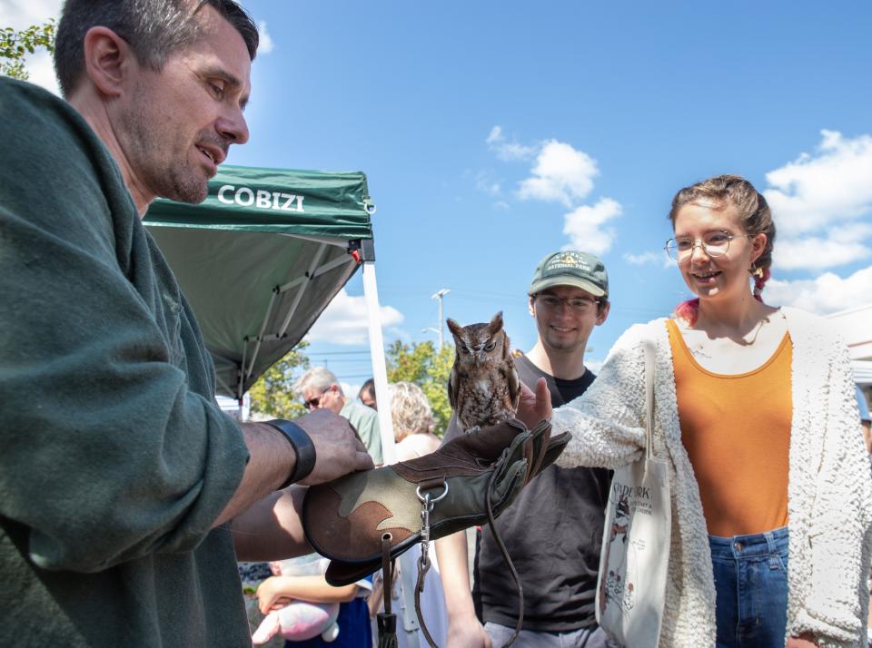 Chris Thomison, of Owl Ridge Raptor Center, educates attendees on owls during Fable Hollow Coffee & Bookshoppe's first annual fall festival Sept. 23, 2023, in Knoxville, Tennessee.