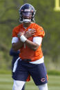 Chicago Bears quarterback Justin Fields (1) signals during drills in the NFL football team's rookie minicamp Friday, May, 14, 2021, in Lake Forest Ill. (AP Photo/David Banks, Pool)