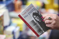 A woman holds the book "The Years" by Annie Ernaux in her hands in a bookstore, in Leipzig, Germany, Thursday, Oct. 6, 2022. 2022's Nobel Prize in literature has been awarded to French author Annie Ernaux. The 82-year-old was cited for “the courage and clinical acuity with which she uncovers the roots, estrangements and collective restraints of personal memory,” the Nobel committee said. (Jan Woitas/dpa via AP)