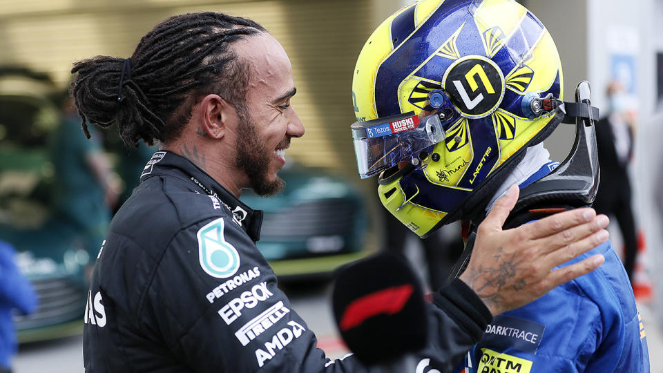 Lewis Hamilton consoled a devastated Lando Norris after the McLaren driver had a near certain victory fall away from him with less that five laps left in the Russian GP. (Photo by Yuri Kochetkov - Pool/Getty Images)