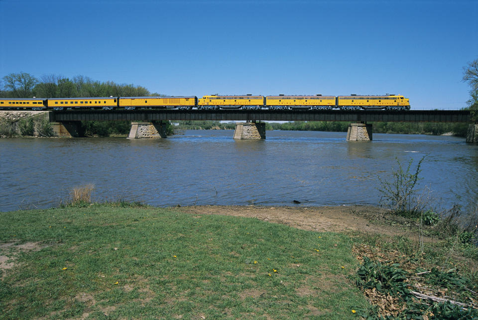 A Union Pacific train on a bridge across a river.