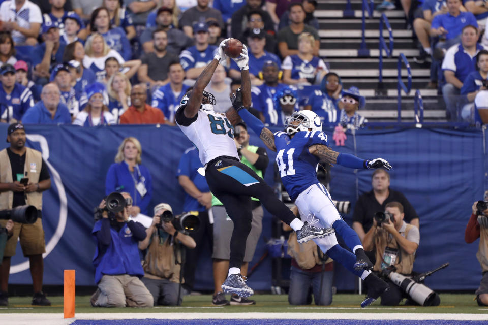 <p>Jacksonville Jaguars tight end Marcedes Lewis (89) catches a pass in the end zone for a touchdown against Indianapolis Colts safety Matthias Farley (41) at Lucas Oil Stadium. Mandatory Credit: Brian Spurlock-USA TODAY Sports </p>