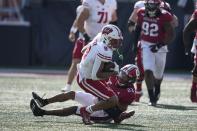 Wisconsin wide receiver Bryson Green (9) is tackled by Indiana defensive back Jordan Shaw (23) during the second half of an NCAA college football game, Saturday, Nov. 4, 2023, in Bloomington, Ind. (AP Photo/Darron Cummings)