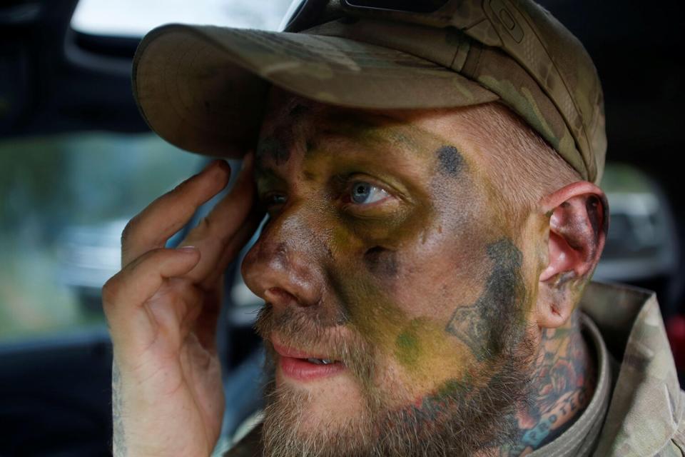 Jason Van Tatenhove, a member of the Oath Keepers, puts on camouflage face paint during a tactical training session in western Montana, U.S. April 30, 2016.