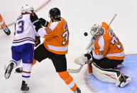 Philadelphia Flyers goaltender Carter Hart (79) makes a save as Montreal Canadiens' Max Domi (13) and Flyers' Derek Grant (38) battle during the third period of an NHL Eastern Conference Stanley Cup hockey playoff game in Toronto, Wednesday, Aug. 12, 2020. (Frank Gunn/The Canadian Press via AP)