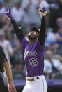 Colorado Rockies' Raimel Tapia gestures as he crosses home plate after hitting a two-run home run off Los Angeles Dodgers starting pitcher Max Scherzer in the fifth inning of a baseball game Thursday, Sept. 23, 2021, in Denver. (AP Photo/David Zalubowski)