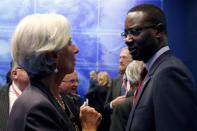 International Monetary Fund Managing Director Christine Lagarde (L) speaks with Swiss bank Credit Suisse CEO Tidjane Thiam at the end of a Farewell Symposium on ultra low interest rates and challenges for central banks, for Bank of France Former Governor Christian Noyer in Paris, France, January 12, 2016. REUTERS/Philippe Wojazer/File Photo