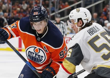 Nov 14, 2017; Edmonton, Alberta, CAN; Edmonton Oilers forward Ryan Nugent-Hopkins (93) and Vegas Golden Knights forward Erik Haula (56) battle after a face-off during the third period at Rogers Place. Mandatory Credit: Perry Nelson-USA TODAY Sports
