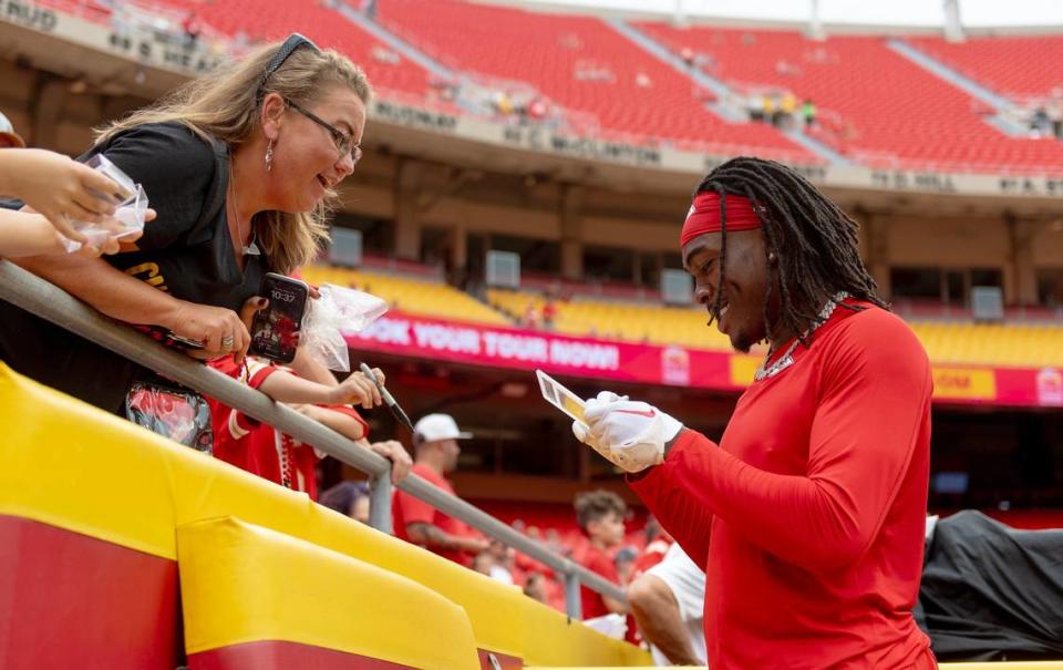 Kansas City Chiefs wide receiver Rashee Rice (4) signs his autograph for a fan before an NFL preseason football game against the Cleveland Browns on Saturday, Aug. 26, 2023, in Kansas City.