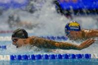 Caeleb Dressel participates in the men's 100 butterfly during wave 2 of the U.S. Olympic Swim Trials on Saturday, June 19, 2021, in Omaha, Neb. (AP Photo/Jeff Roberson)