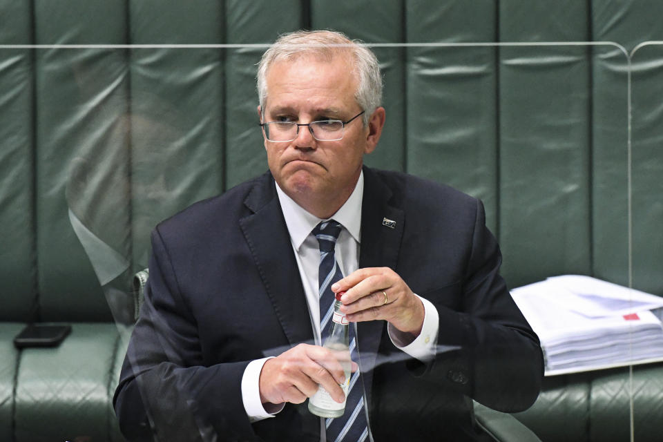 **EMBARGOED UNTIL 13:00 GMT WEDNESDAY, OCT. 20** Australian Prime Minister Scott Morrison has as drink of water during Question Time in Parliament House in Canberra, Wednesday, Oct. 20, 2021. Australia was the worst climate performer among comparable developed countries since the 2015 Paris Agreement imposed binding commitments to limit global warming, a think tank reported on Thursday Oct. 21, 2021, ahead of an important conference in Scotland later this month. (Lukas Coch/AAP Image via AP)