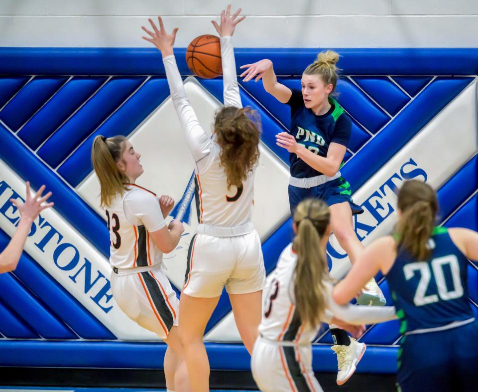 Peoria Notre Dame's Mya Wardle (22) tries to pass to a teammate through Washington's Claire McDougall (3) and Carly Vaugn in the first half of the Class 3A Girls Basketball Limestone Regional title game Thursday, Feb. 16, 2023 in Bartonville. The Panthers defeated the Irish 59-48.