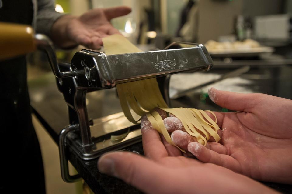 Fresh pasta is pressed and cut during a cooking class on Friday, Dec. 15, 2017, at The Cooking Studio on North College Avenue in Fort Collins, Colo. 