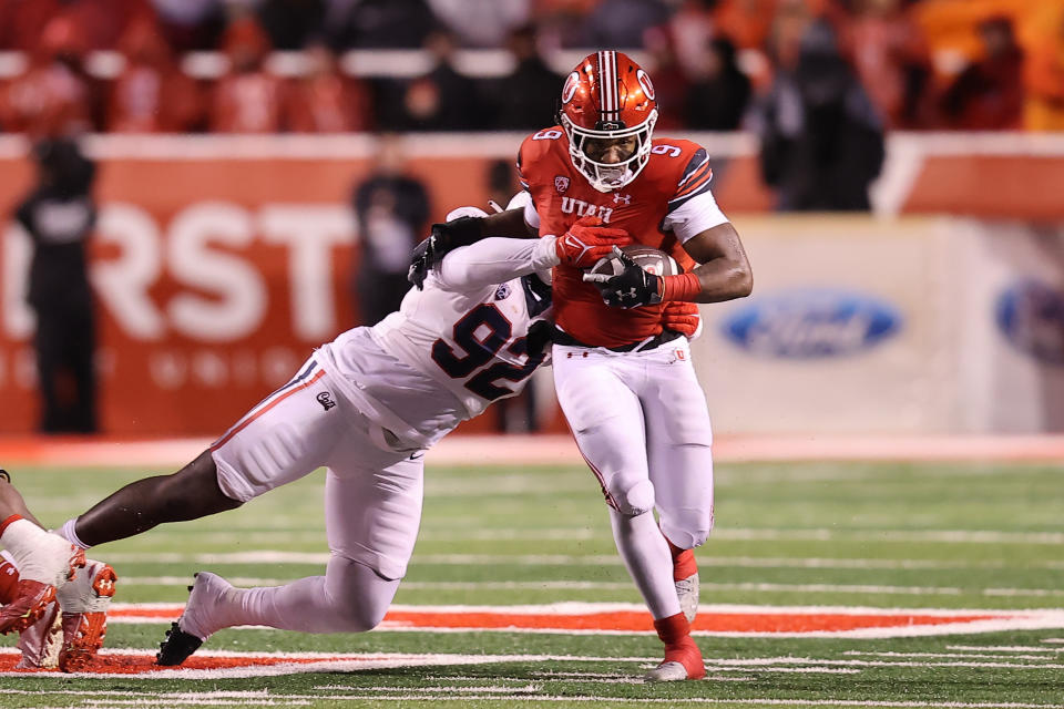 Nov. 5, 2022; Salt Lake City; Utah Utes running back Tavion Thomas (9) runs the ball against Arizona Wildcats defensive lineman Kyon Barrs (92) in the fourth quarter at Rice-Eccles Stadium. Rob Gray-USA TODAY Sports