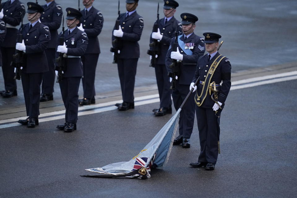 The Kings Colour is lowered as the coffin of Queen Elizabeth II departs RAF Northolt, west London, Tuesday, Sept. 13, 2022, from where it will be taken to Buckingham Palace, London, to lie at rest overnight in the Bow Room. (Andrew Matthews/Pool Photo via AP)