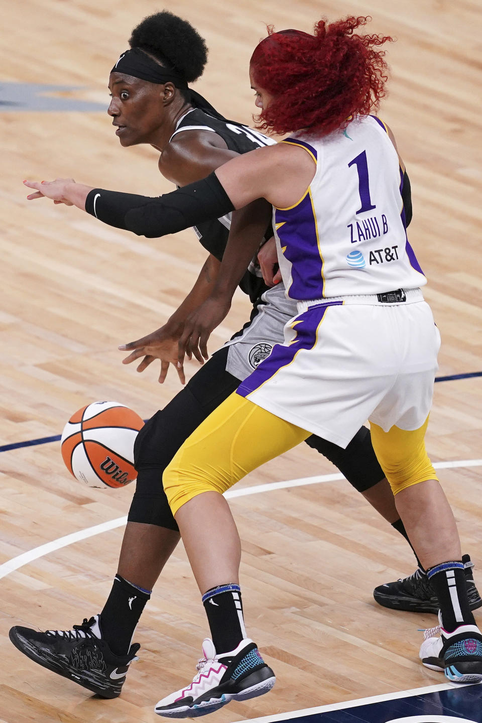 Minnesota Lynx center Sylvia Fowles (34) looks for an open teammate to pass to as Los Angeles Sparks center Amanda Zahui B (1) defends during the second quarterof a WNBA basketball game Saturday, June 12, 2021, in Minneapolis. (Anthony Souffle/Star Tribune via AP)