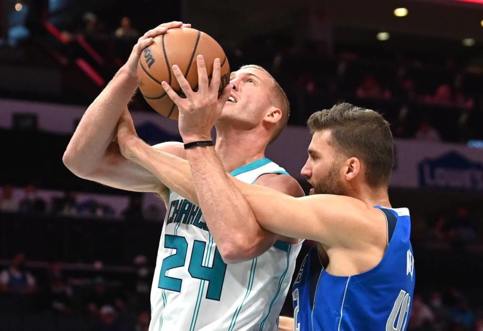 Charlotte Hornets center Mason Plumlee, left, is fouled by Dallas Mavericks forward/center Maxi Kleber, right, during first half action on Wednesday, October 13, 2021 at Spectrum Center in Charlotte, NC.