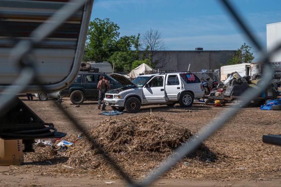 Homeless campers ready their vehicles to move from an encampment near Lexington Street and Dixieanne Avenue in Old North Sacramento that was cleared by city crews on Wednesday, May 25, 2022. The city of Sacramento is leasing the vacant lot to an auto repair company for free, in order to clear the homeless encampment.