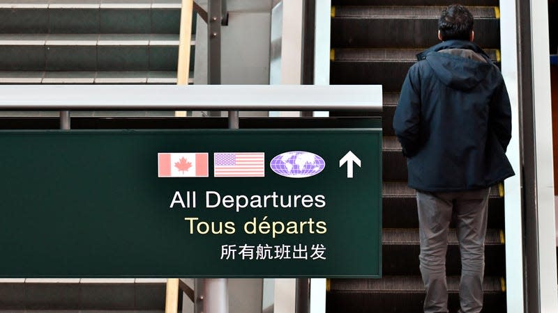 An escalator and staircase heading toward the departures area at Vancouver International Airport - Photo: Jennifer Gauthier (Reuters)