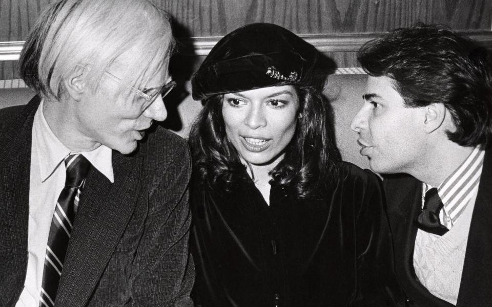 Bianca Jagger, journalist Bob Colacello, and Andy Warhol in the 70s - Getty