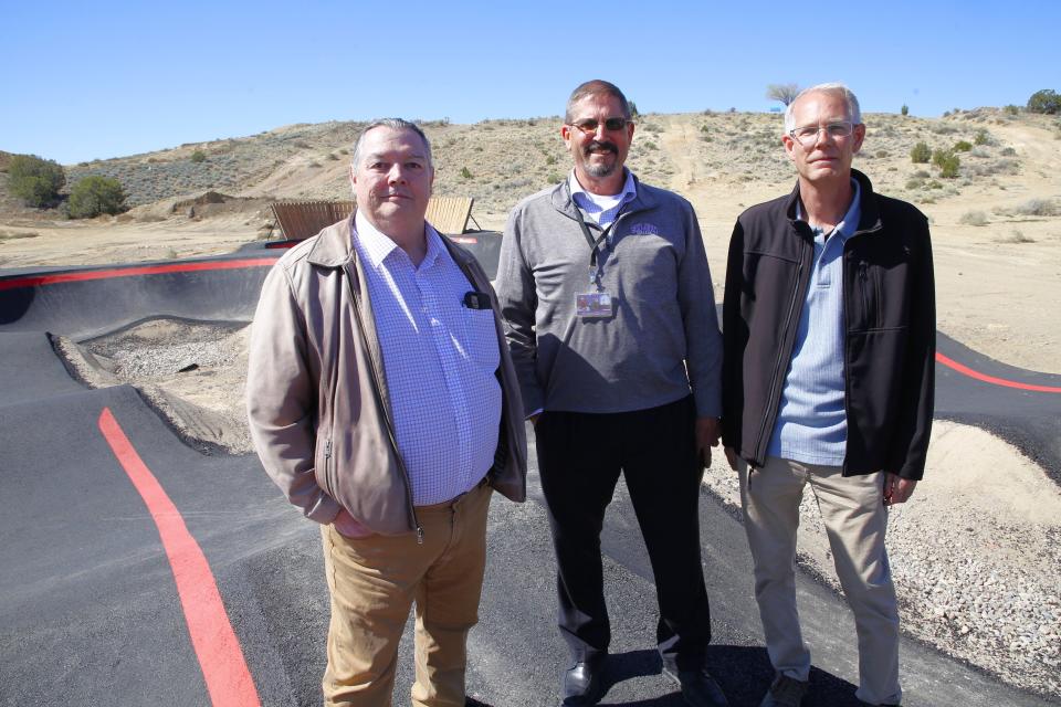 San Juan College Executive Vice President Ed DesPlas, left; Jon Betz, director of the college's Health and Human Performance Center; and Chris Harrelson, the senior director of the college's physical plant, pose on the new pump track at the college's bike park on Wednesday, April 17.