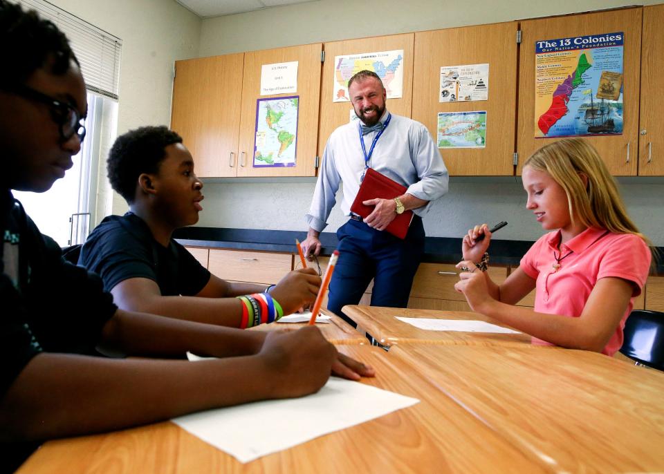 Martin County School District Superintendent John Millay (center) talks with 8th-grade civics students Cailen Jones (right), 12, Komorian Wynter (left), 13, and Marcus Rogers, 13, while visiting Murray Middle School on the first day of school Wednesday, Aug. 10, 2022, in Port Salerno.