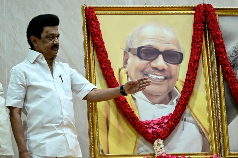 Dravida Munnetra Kazhagam (DMK) party president M.K. Stalin, standing beside a portrait of his father M. Karunanidhi (R. Satish BABU)