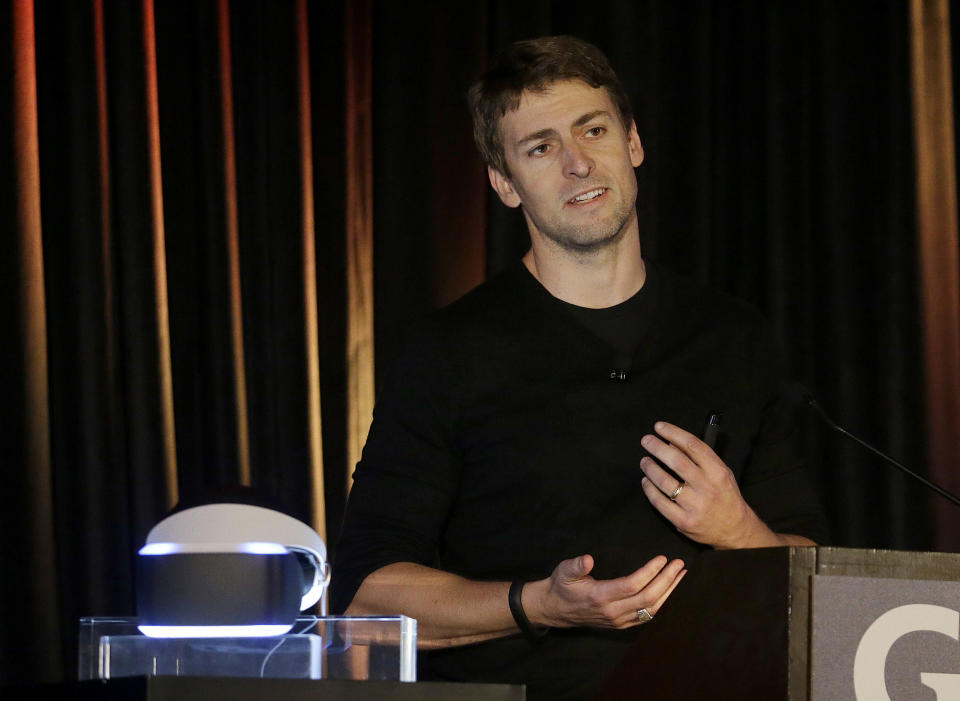 Richard Marks, senior director of research and development at Sony Computer Entertainment America, speaks about the PlayStation 4 virtual reality headset Project Morpheus, pictured at left, at the Game Developers Conference 2014 in San Francisco, Tuesday, March 18, 2014. (AP Photo/Jeff Chiu)