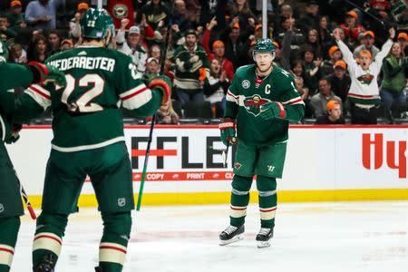 Nov 15, 2018; Saint Paul, MN, USA; Minnesota Wild forward Mikko Koivu (9) celebrates after a goal scored by forward Nino Niederreiter (22) during the second period against the Vancouver Canucks at Xcel Energy Center. Brace Hemmelgarn-USA TODAY Sports