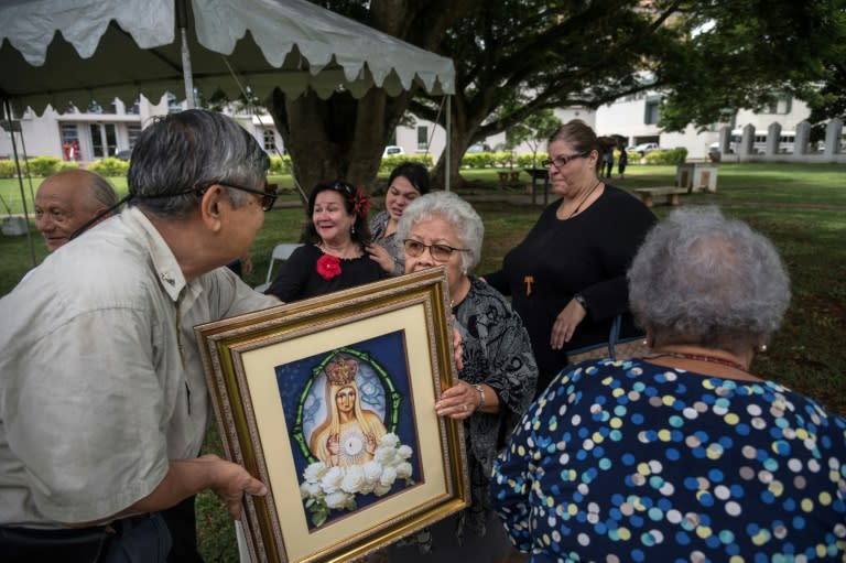 Catholic worshippers attend a "prayers for peace" rally marking the 100th anniversary of Our Lady of Fatima in Hagatna on August 13, 2017