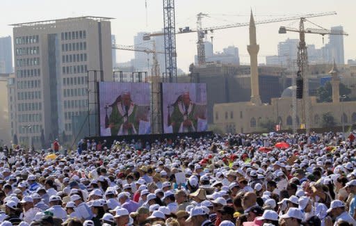 People wait for Pope Benedict XVI to attend an open-air mass at Beirut's waterfront on the final day of his visit to Lebanon. Pope Benedict XVI prayed on Sunday that Middle East leaders work towards peace and reconciliation, stressing again the central theme of his visit to Lebanon, whose neighbour Syria is engulfed in civil war