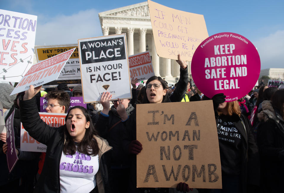 Pro-abortion-rights activists outside the U.S. Supreme Court in Washington, D.C., on Friday hold signs in response to anti-abortion activists participating in the March for Life, an annual event to mark the anniversary of <em>Roe v. Wade</em>. (Photo: Saul Loeb/AFP/Getty Images)