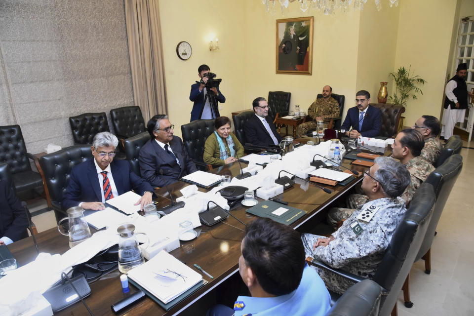 In this photo released Pakistan's Prime Minister office, the caretaker Prime Minister Anwaarul-Haq-Kakar, center right, chairs a meeting of the National Security Committee, in Islamabad, Pakistan, Friday, Jan. 19, 2024. Pakistan's top political and military leadership decided to de-escalate tension with Iran after tit-for-tat airstrikes, a day after Islamabad launched retaliatory airstrikes against alleged militant hideouts inside Iran, killing at least nine people, officials said. (Prime Minister Office via AP)