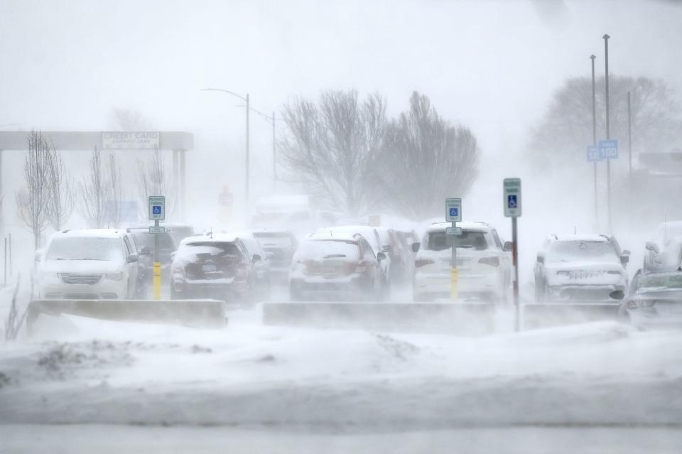 Snow blows across the parking lot at Capital Region International Airport on Friday, Dec. 23, 2022, in Lansing.
