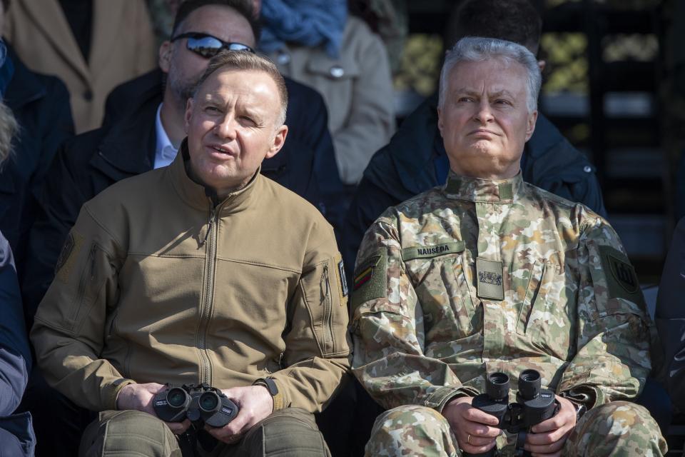 Poland's President Andrej Duda, left, and Lithuania's President Gitanas Nauseda sit together to watch a Lithuanian-Polish Brave Griffin 24/II military exercise near the Suwalki Gap near the Polish border at the Dirmiskes village, Alytus district west of the capital Vilnius in Lithuania on Friday, April 26, 2024. Over 1500 troops and 200 pieces of tactical equipment are rehearsing defence scenarios under the bilateral Lithuanian-Polish Orsha Plan near the Suwalki Gap. (AP Photo/Mindaugas Kulbis)